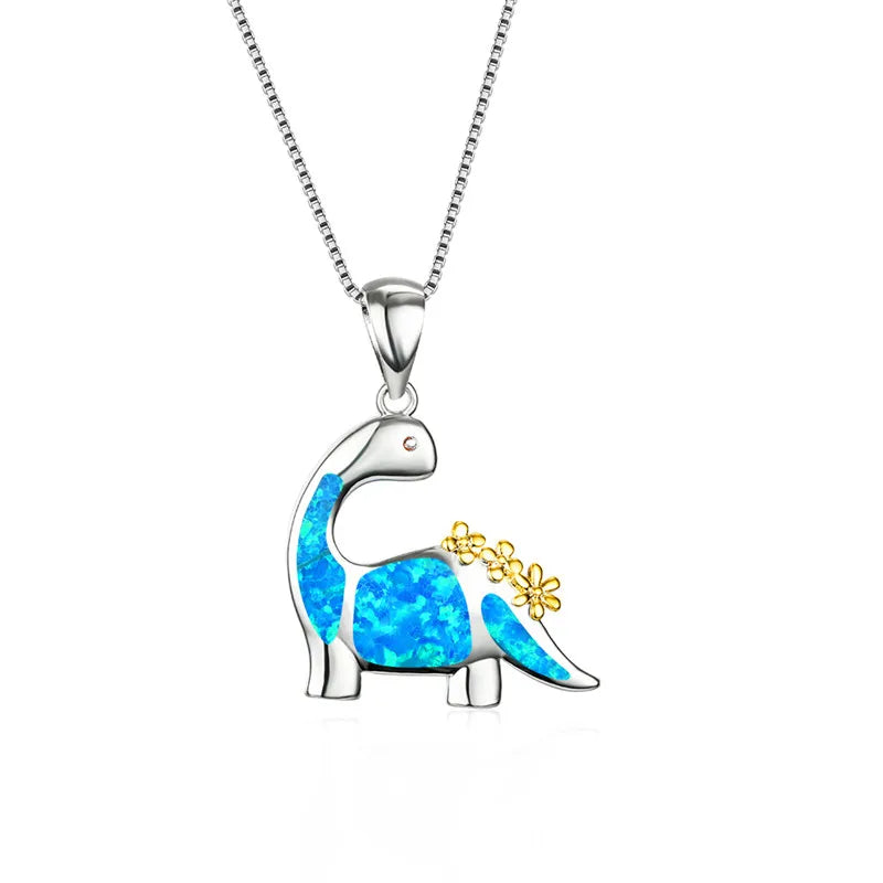 Dinosaur-shaped pendant with blue opal and gold accents on a white background