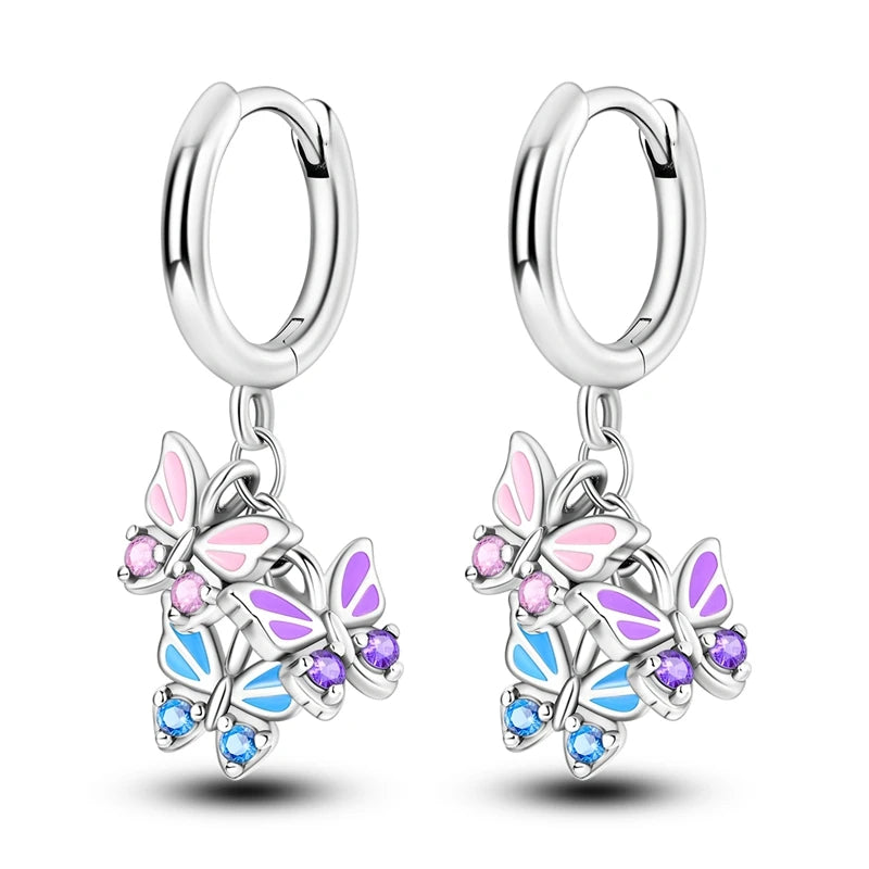 Butterfly-shaped earrings with colorful accents on a white background