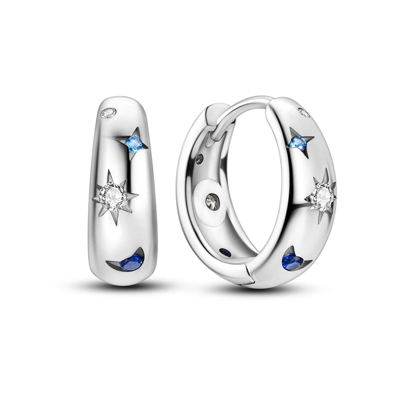 Silver hoop earrings with star and moon designs on a white background
