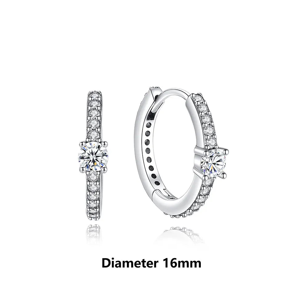 Pair of silver hoop earrings with clear gemstones on a white background