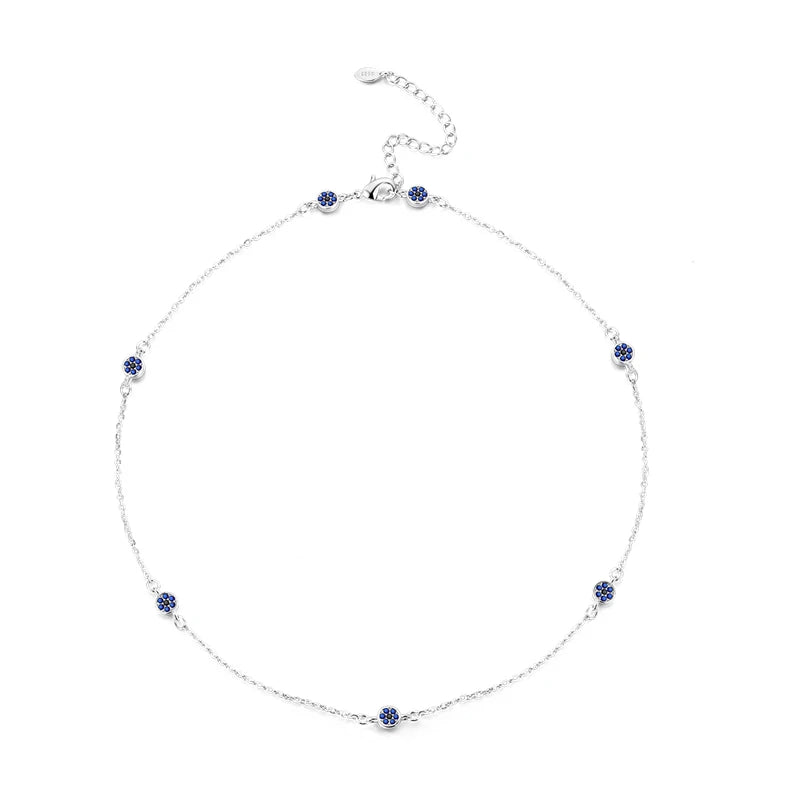 Silver necklace with blue gemstones on a white background